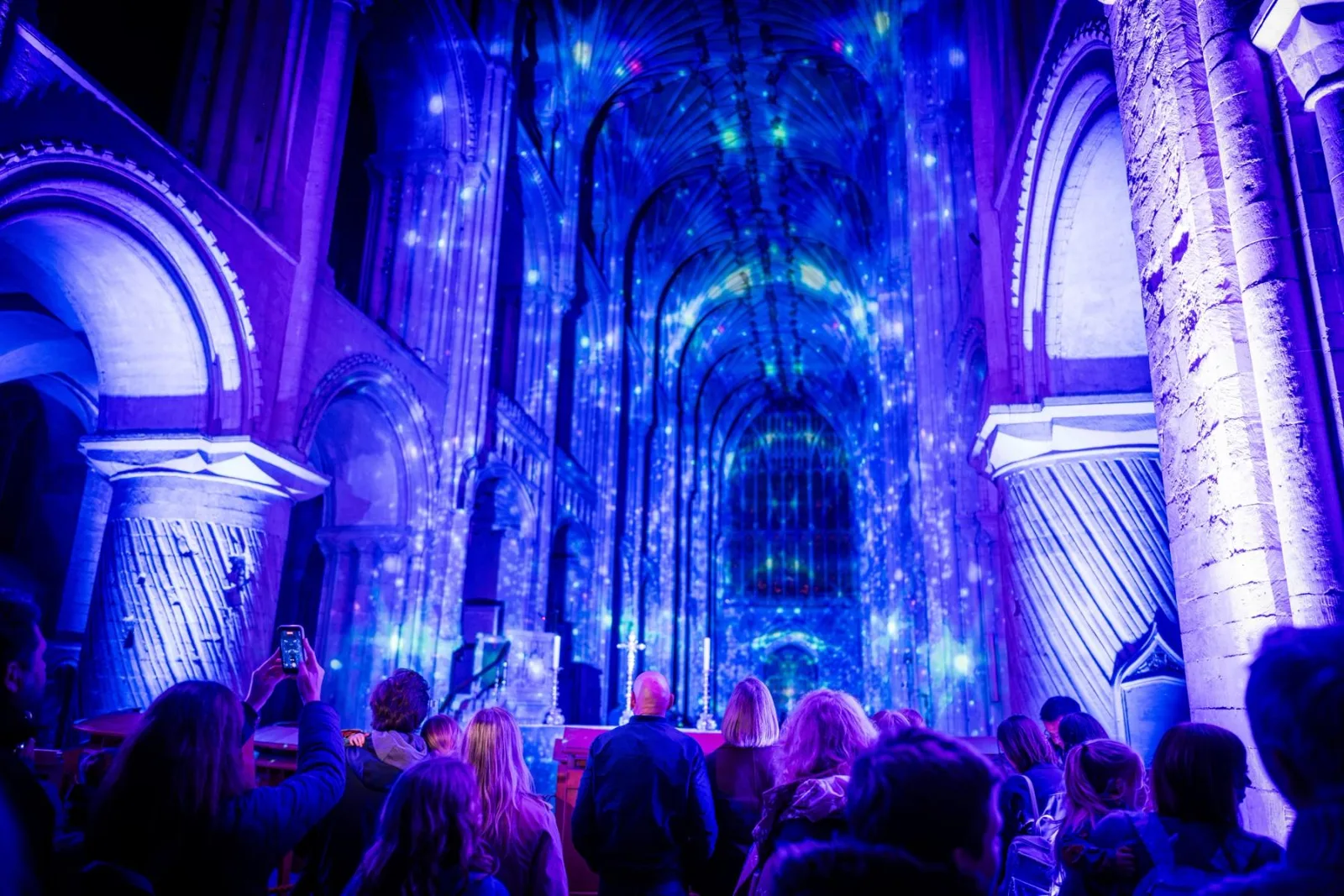Visitors in the nave of Norwich Cathedral during Time by Luxmuralis.